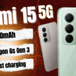 Redmi 15 5G thumbnail showcasing key specs: 7,000mAh battery, Snapdragon 6s Gen 3 chipset, and 33W fast charging, with phone images on a bold red cracked background.
