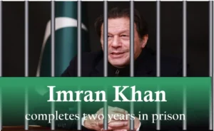 Imran Khan behind jail bars with a green banner reading "Imran Khan completes two years in prison