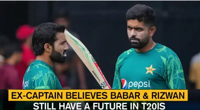 Two Pakistani cricketers, Babar Azam and Mohammad Rizwan, in training jerseys during a T20I match preparation, discussing strategy on the field.